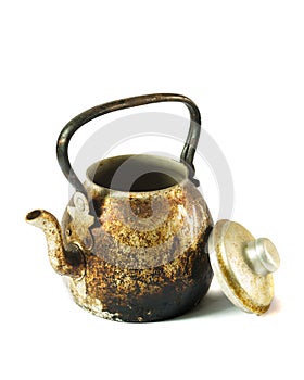 An old kettle with fire burns and dirt