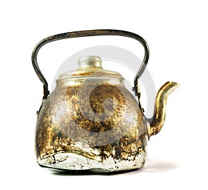 An old kettle with fire burns and dirt