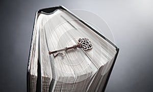 Old key with bible. Concept of wisdom and knowledge