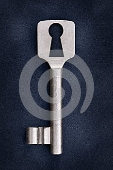 Old key on a dark blue background with unusual key