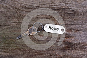 Old key With Hope Text. Wooden texture background