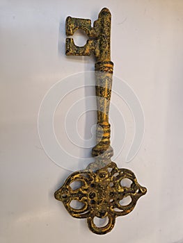 Old key isolated on white. Ornate, gold master key on white with clipping path