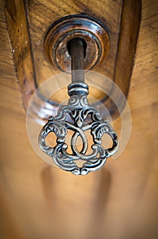 Old key in keyhole, macro shot. Retro style. Concept and Idea for History, business, security background.