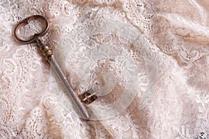 Old key on lace fabric