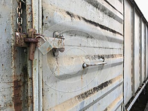 Old key lock on rusty freight container