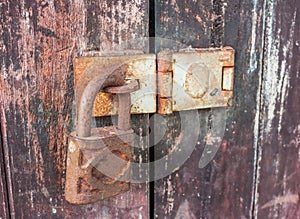 Old key lock on wooden wall