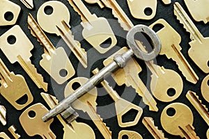 Old key and many yellow ones as symbol of right decision or find the key