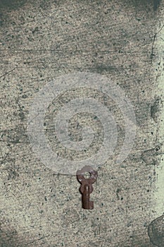 Old key on the old textured paper with natural patterns