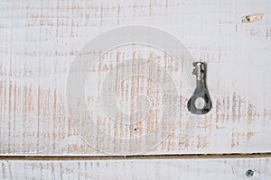 The old key on a white wooden background. top view