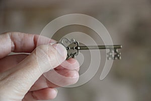 Old key in woman hand. Confidentiality concept. Business success concept