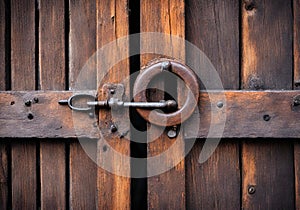 Old keyrole lock of a wooden slatted door.