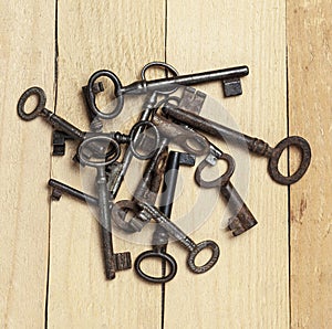 Old keys on a background of wooden boards
