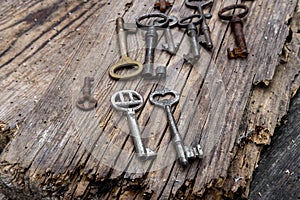 Old keys of different sizes on rustic weathered wood planks