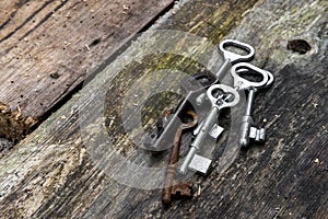 Old keys of different sizes on rustic weathered wood planks