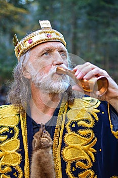 Old king drinking from the goblet