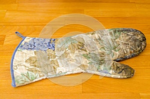 Old kitchen glove isolated on a table