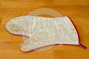 Old kitchen glove isolated on a table