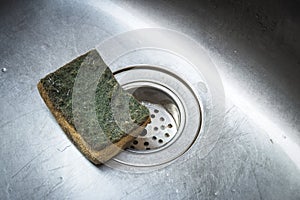 Dirty scrub sponge in a sink ,Old Kitchen Sponge Could Give Diarrhea photo