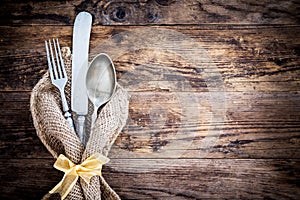 Old knife, spoon and fork decoratively presented.