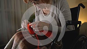 Old knitting woman feeling desperate of shaking hands illness, hopelessness