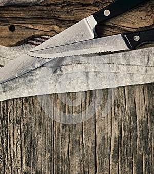 Old knives and Chopping board on wooden background