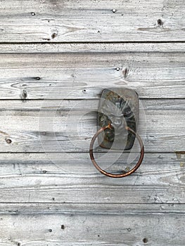 Old knocker on the wooden door