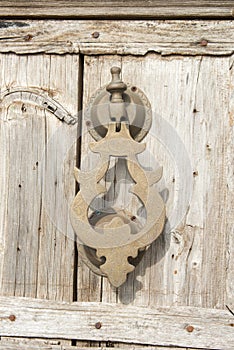Old knocker on a wood door