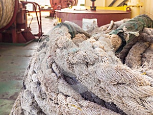 Old knotted nautical ropes. mooring ropes, close up. Deck of a cargo ship. Sea Shipping concept