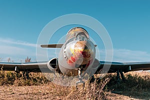 Old L-29 military plane on airbase with blue sky