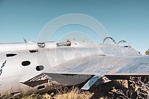 Old L-29 plane fuselage and wing close in field photo