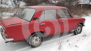 The old Lada on a snowy background