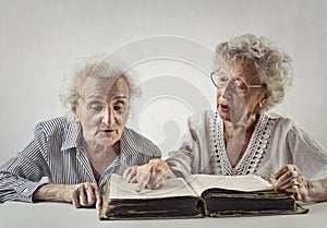 Old ladies try to read together