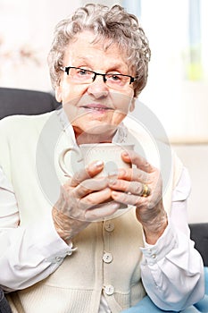 old lady drinking a brew of herbs