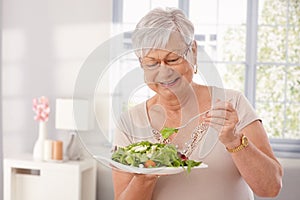 Old lady eating green salad