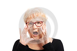 An old lady expresses shock/ surprise.