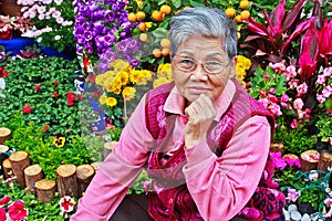 Old lady in front of Flower garden