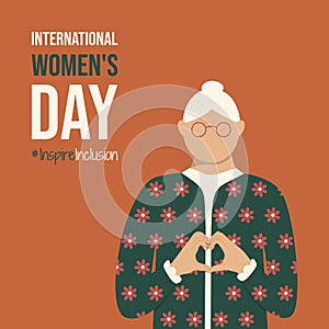 Old lady on International Women\'s Day 2024 postcard. Woman shows Heart Shape with hands on spring IWD InspireInclusion photo