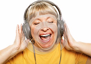 old lady isolated on white listening to music on the phone