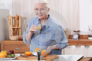 Old lady making orange juice.
