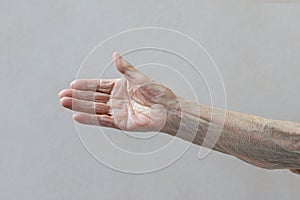 Old lady`s hand. Elderly lady is waiting for help. Elderly concept with light background