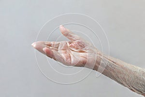 Old lady`s hand. Elderly lady is waiting for help. Elderly concept with light background