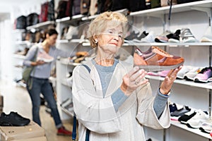 Old lady shopping in shoestore