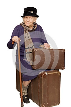 The old lady sits on a suitcase