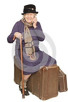 The old lady sits on a suitcase