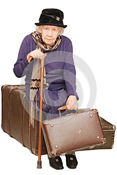 The old lady sits on a suitcase