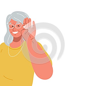 The old lady smiles and holds her hand near her ear.The elderly woman listening or hearing intently.