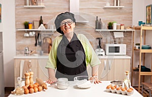 Old lady wearing chef apron and bonete photo