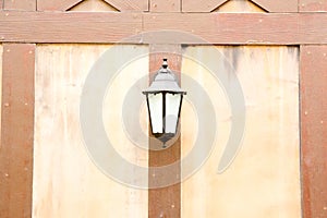 Old lamp lantern on the stone wall