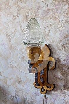 An old lamp that may have been made by hand hangs on the wall.