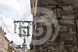 Old Lamp post and caffe sign vintage stone wall in lviv